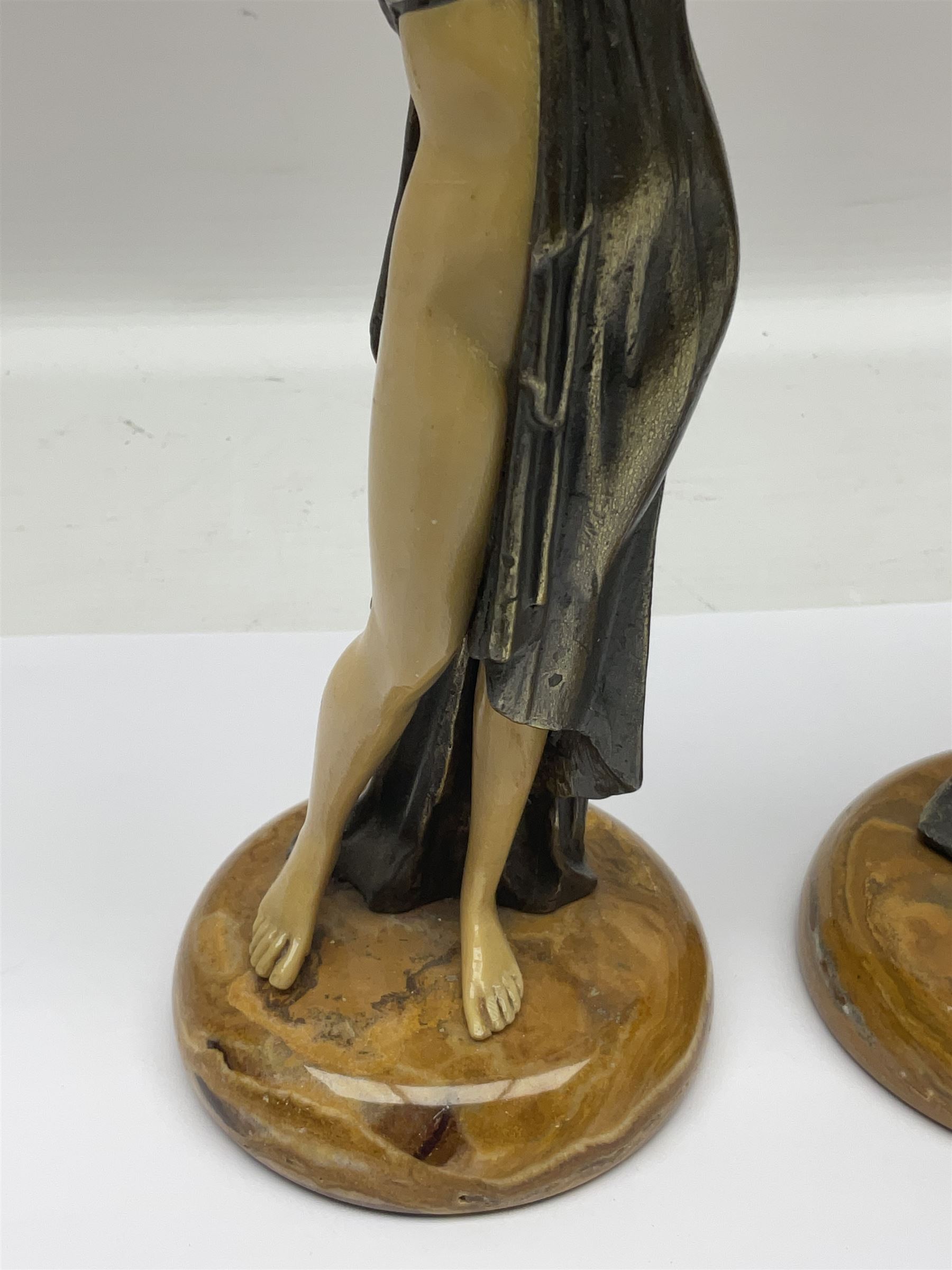 After Ferdinand Preiss (1882-1943), pair of Art Deco style, composite semi nude classical female figures, raised on circular onyx bases, H21cm