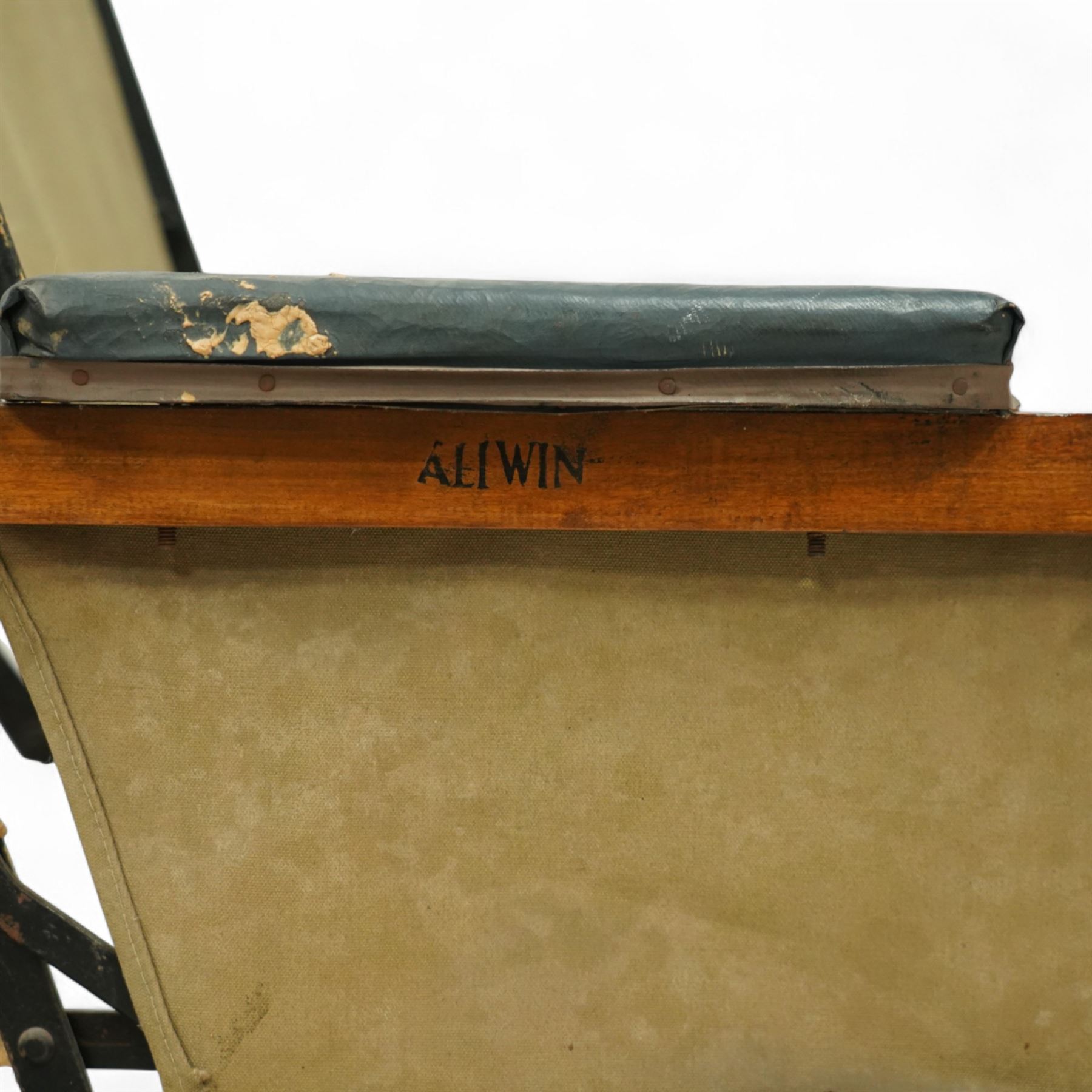 *Early 20th century invalid chair, the tubular metal frame with folding mechanism, canvas seat and back, padded armrests, raised on coil springs and large spoked wheels with wooden footrestFrom the Kirkham Hall Attic & Cellar Collection, sold without reserve