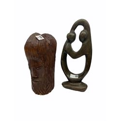 Abstract stone sculpture, H33cm, together with a carved wooden sculpture depicting two male faces H27cm.