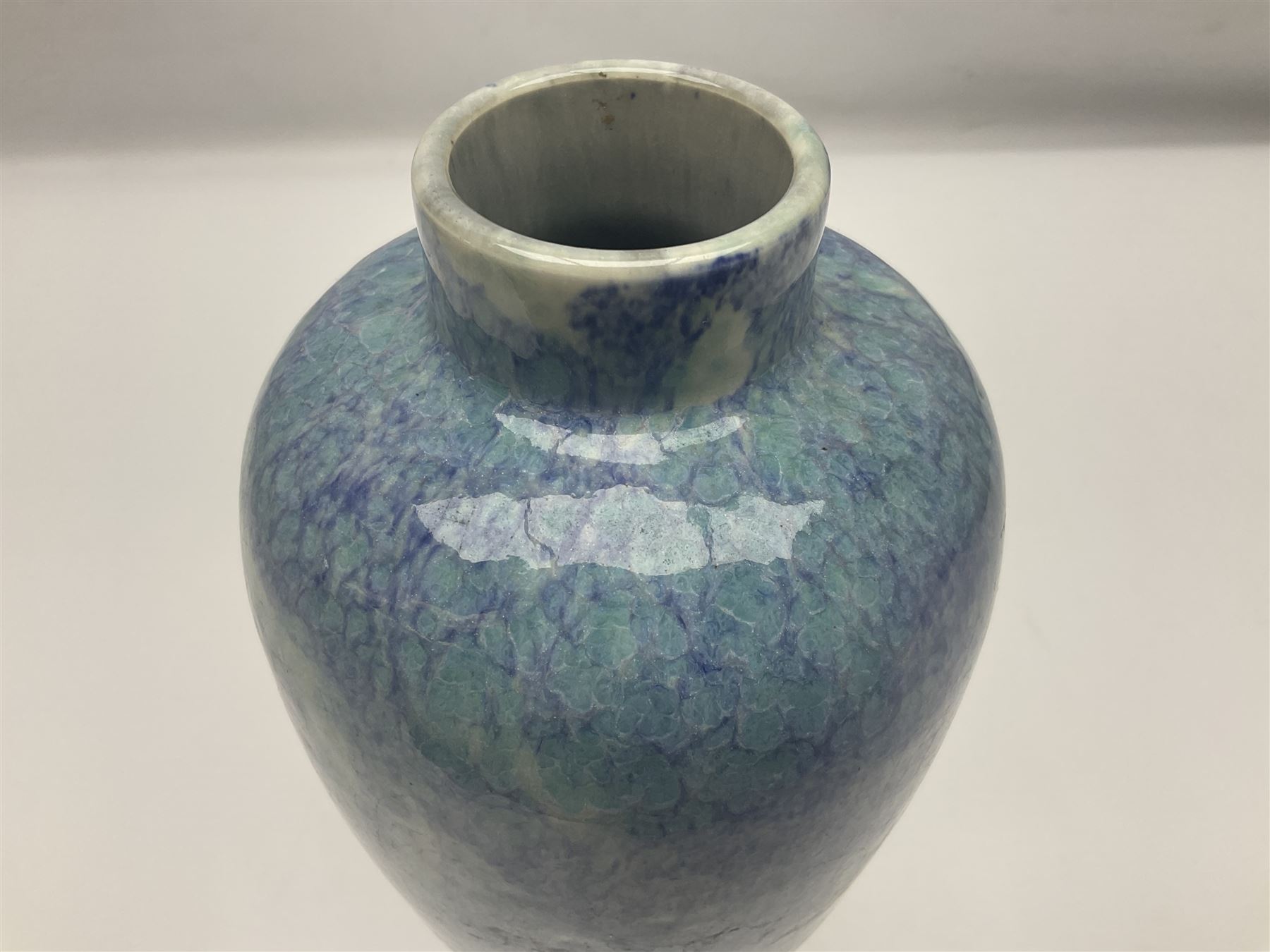 Holyrood Pottery vase of bulbous form decorated in a mottled and streaked green and blue glaze, with printed mark beneath, H24cm