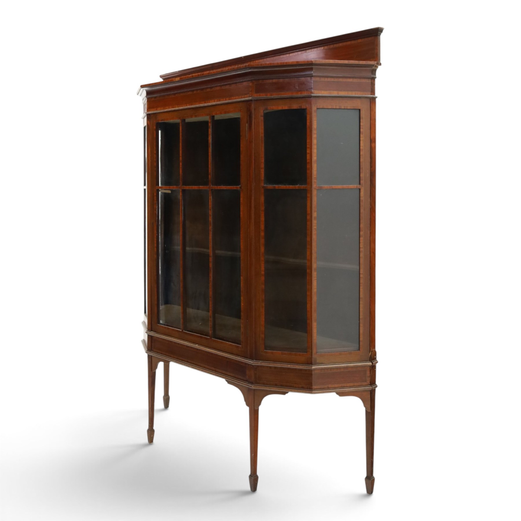 Edwardian inlaid mahogany display cabinet of rectangular canted form, galleried top with crossbanded inlay, above a glazed cabinet enclosing  baize lined shelves, raised on square tapering legs terminating in spade feet  