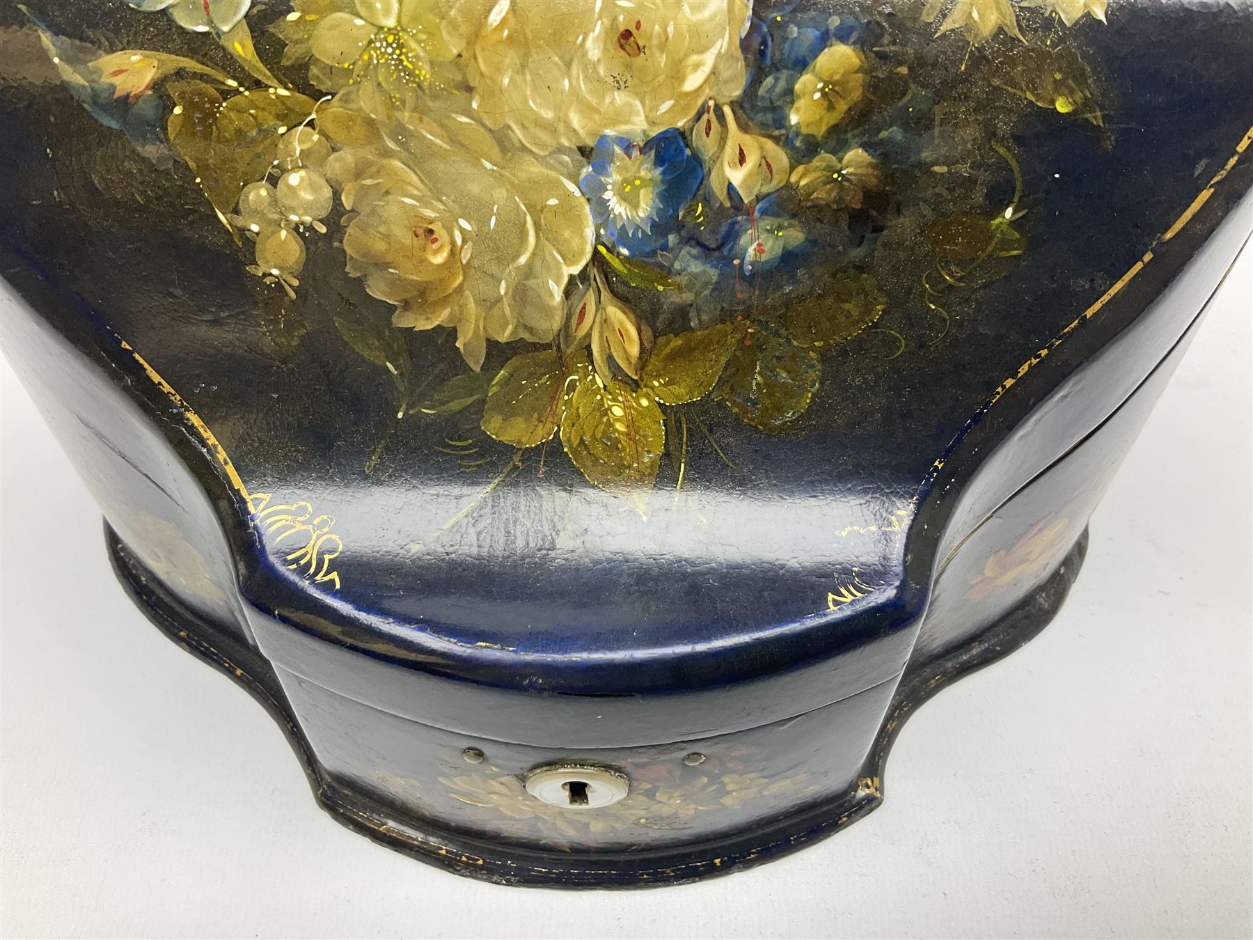 Victorian papier-mâché stationary box, of rounded wedge form with mother of pearl escutcheon, the hinged and curved cover and sides hand painted with floral sprays, opening to reveal a lined and fitted interior, H15cm L22cm D16cm