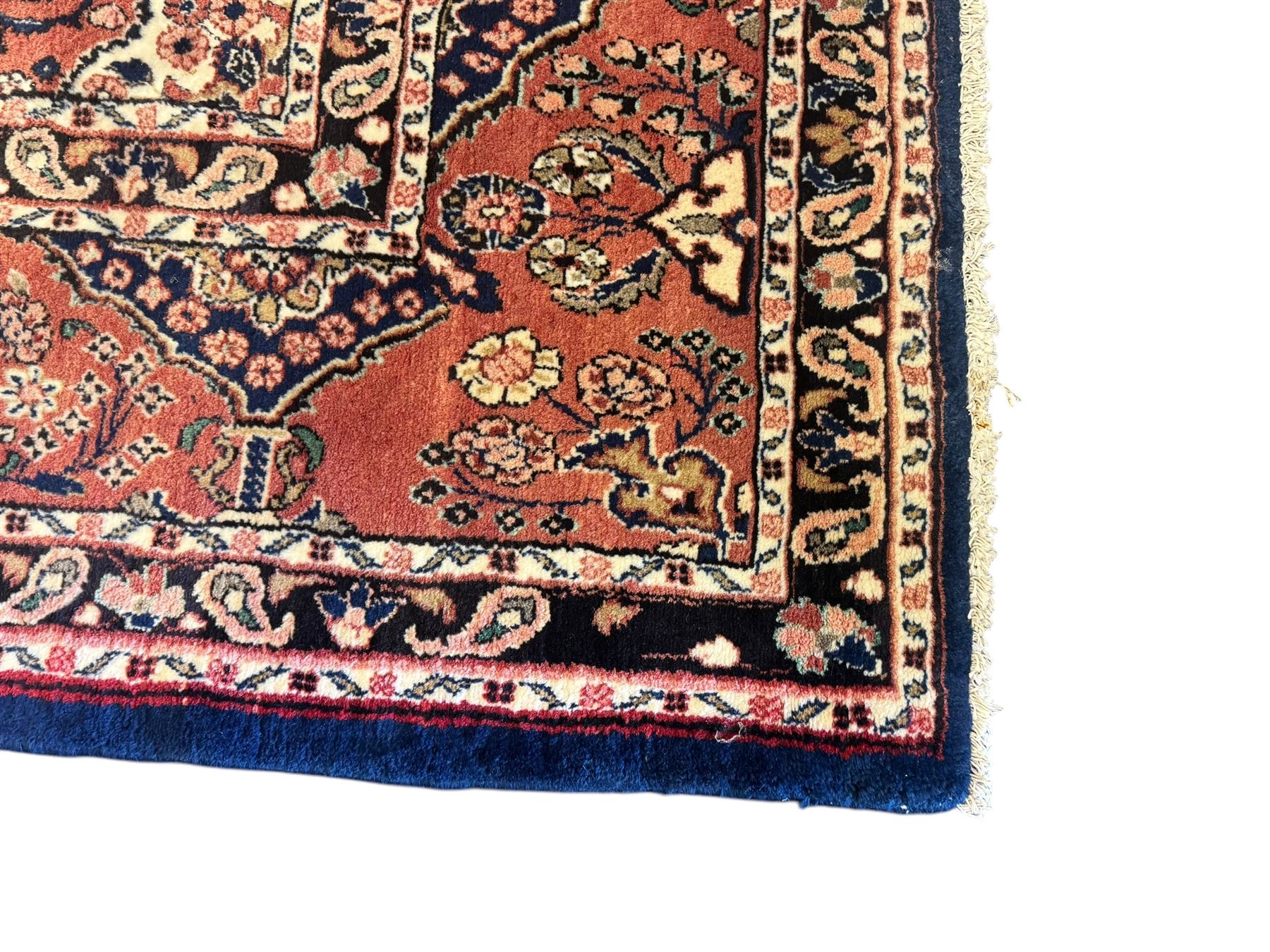 Persian Herati design indigo and red ground carpet, decorated with floral motifs, arched border
