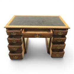 Oak twin pedestal desk with leather top, moulded rectangular top with inset black leather writing surface, nine fielded panelled drawers with brass handles, raised on a plinth base with castors