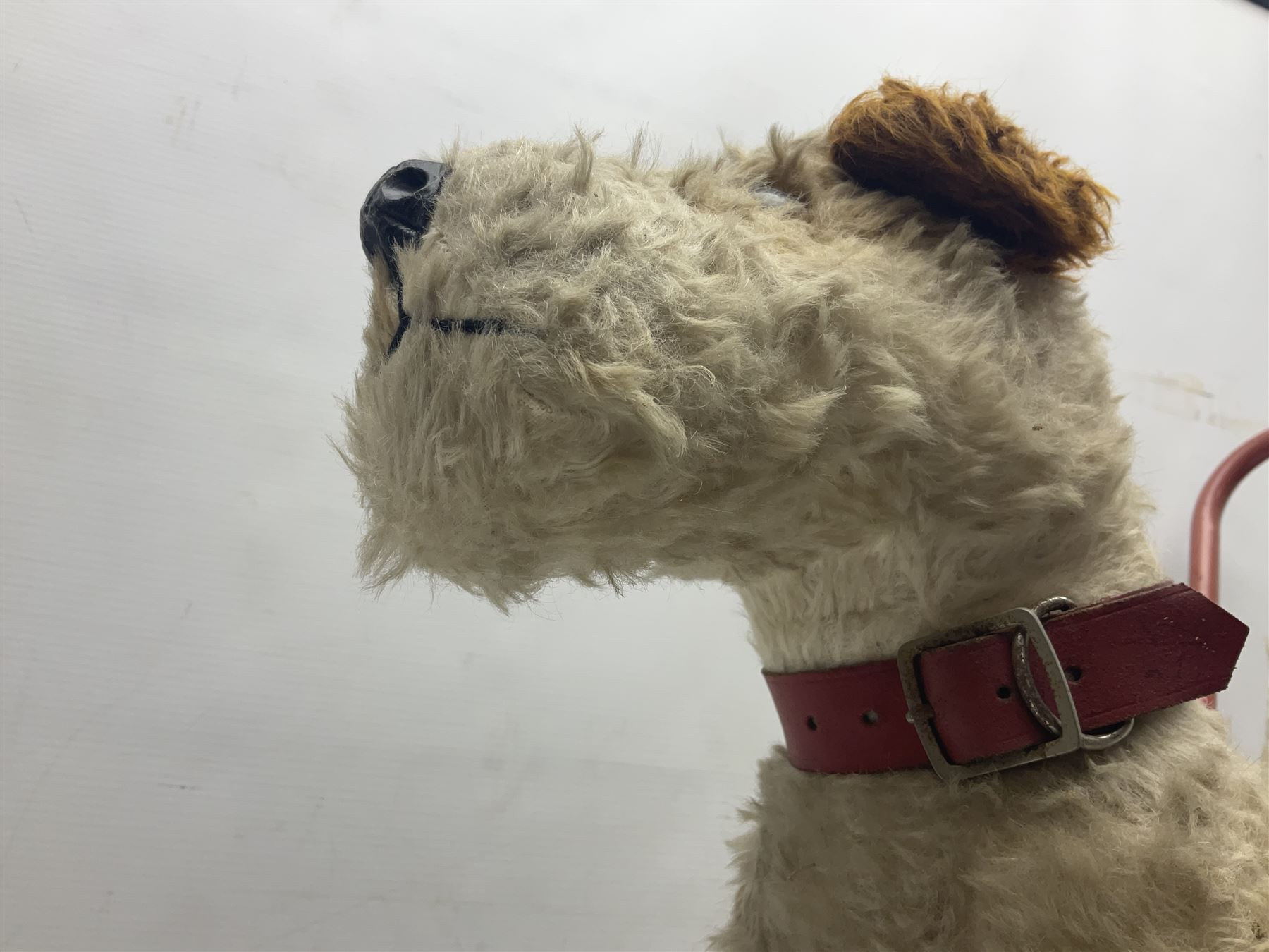 Tri ang - Pedigree Soft Toys - push along/ride-on dog as a wood wool filled plush Airedale terrier in red tubular frame with beech footrests and black rubber wheels; stitched Northern Ireland label in tact L60cm H61cm