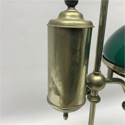 William H Honey polished brass adjustable student's oil lamp, with green glass shade, H60cm