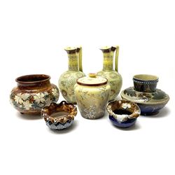 A group of Doulton Lambeth, to include a pair of Slaters Patent ewers with press moulded foliate decoration and yellow ground, H22cm, a jar of squat bulbous form decorated with white flowers upon a mottled brown ground, upon three nub feet, etc. 