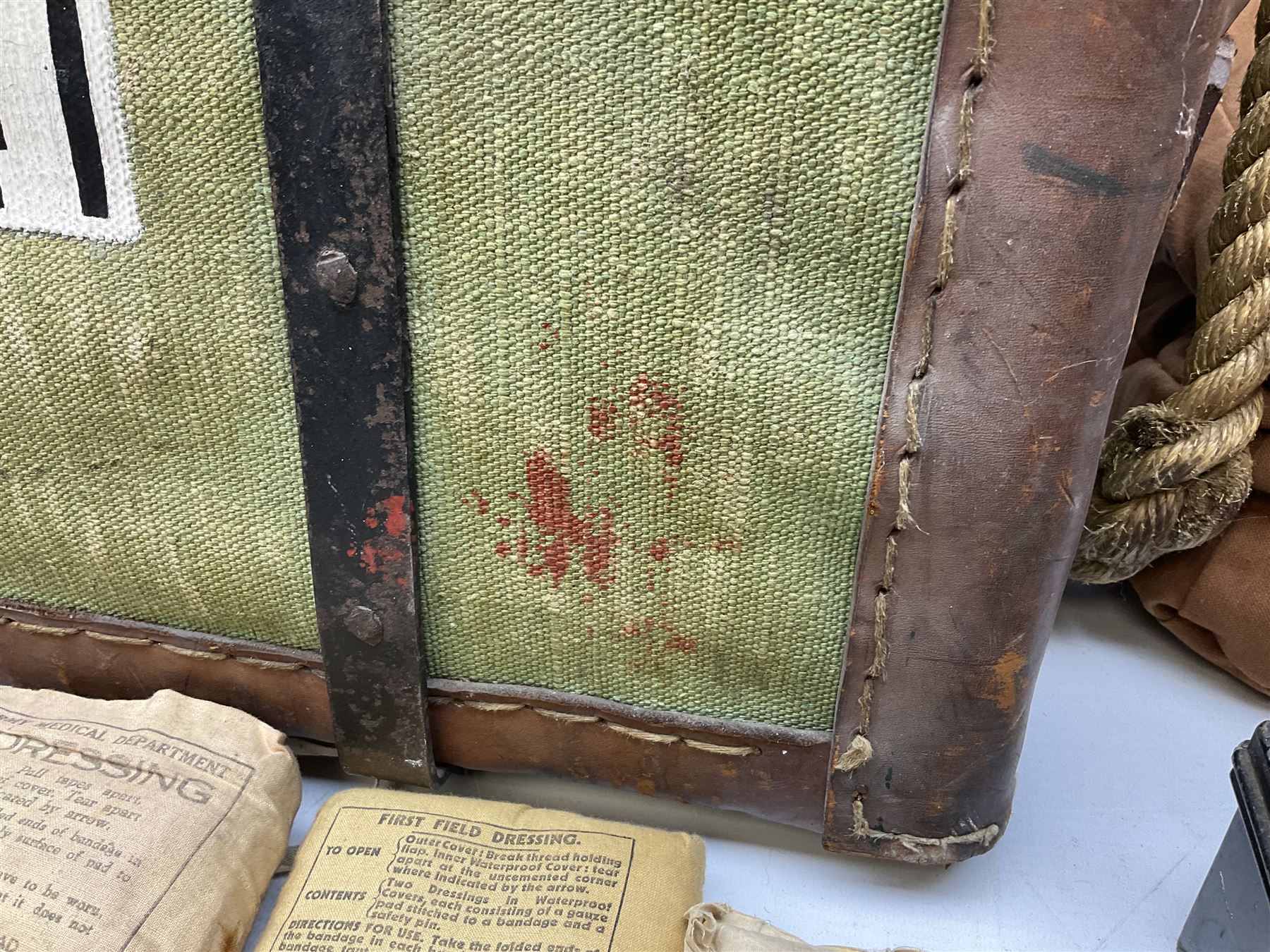 WW2 British Army RAMC 'Regimental Medical Pannier', well marked externally and dated 1941, stamped May 1943 internally, canvas covered wicker form with leather edges, hinged top and fall front with two rope carrying handles, fitted iron locking straps with securing chains; contains various unused field dressings and bandages with WW2 dates and two pillows; original label under lid L79cm