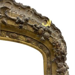 19th century giltwood and gesso moulded picture or mirror frame, the arched cresting rail mounted by central cartouche decorated with foliate scrolls and fruit, the outer frame decorated with scalloped edge and shell mouldings, trailing foliage with flower head and fruit to the central band, egg and dart moulded inner slip