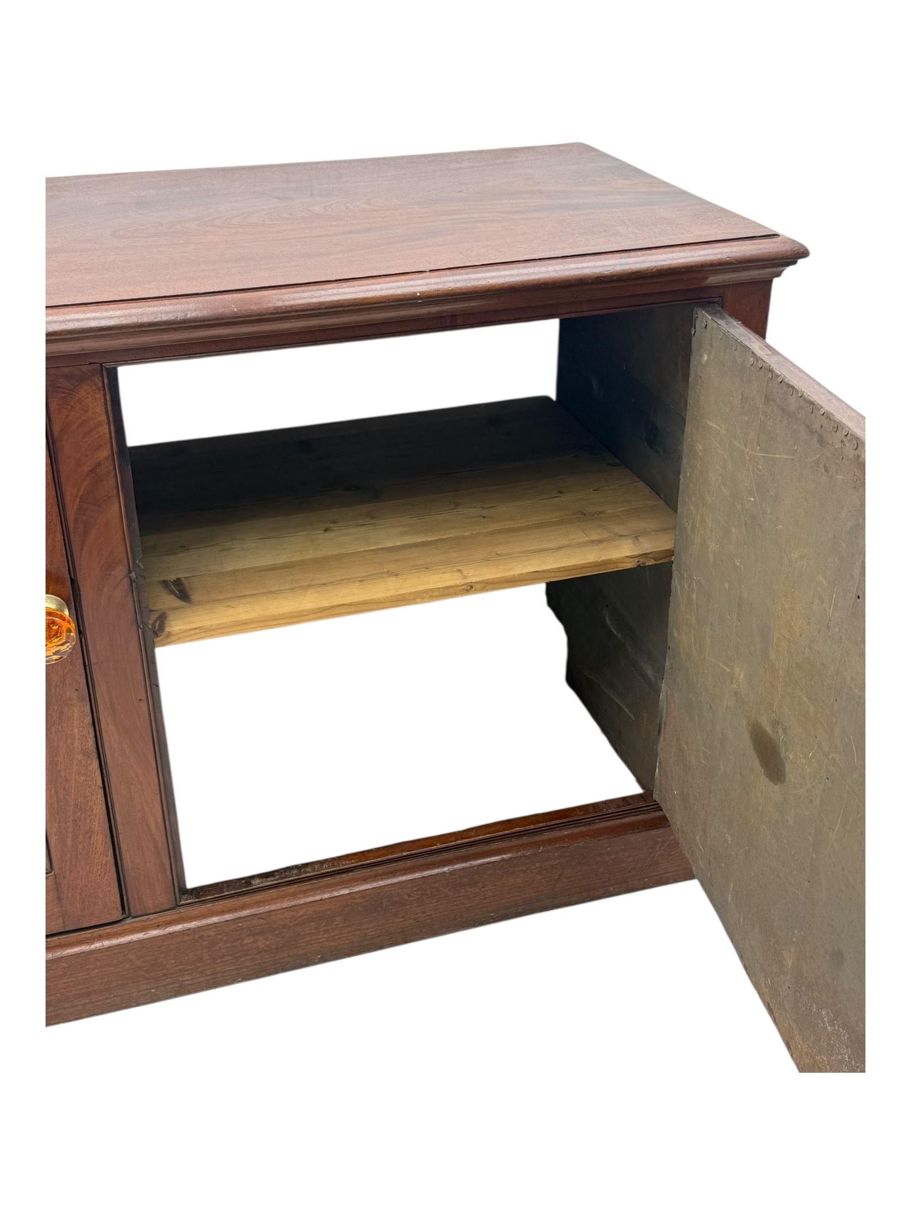 Victorian mahogany cupboard, plain rectangular top above two fielded panel doors opening to shelved interior, raised on a moulded plinth base, with later replacement knob handles