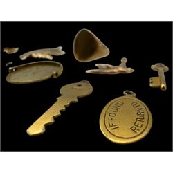 9ct gold charms, including crossed swords, signet ring, horseshoe and leaf, and a 14ct gold fireplace charm