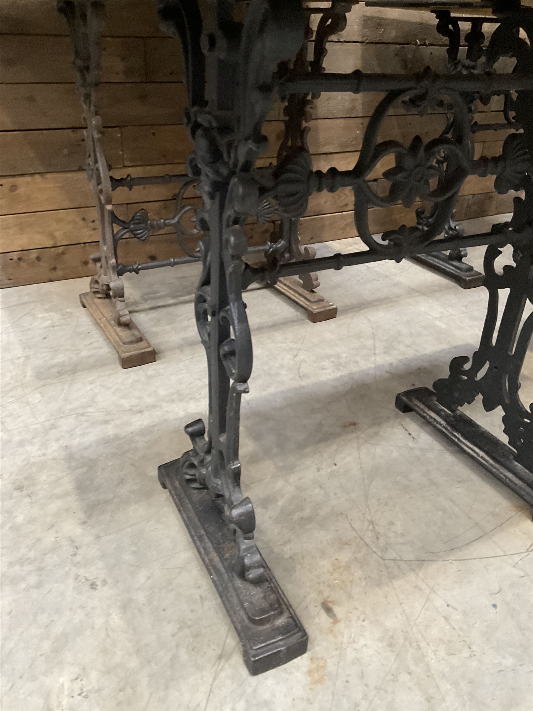 Four cast iron pub or bar tables with rectangular tops