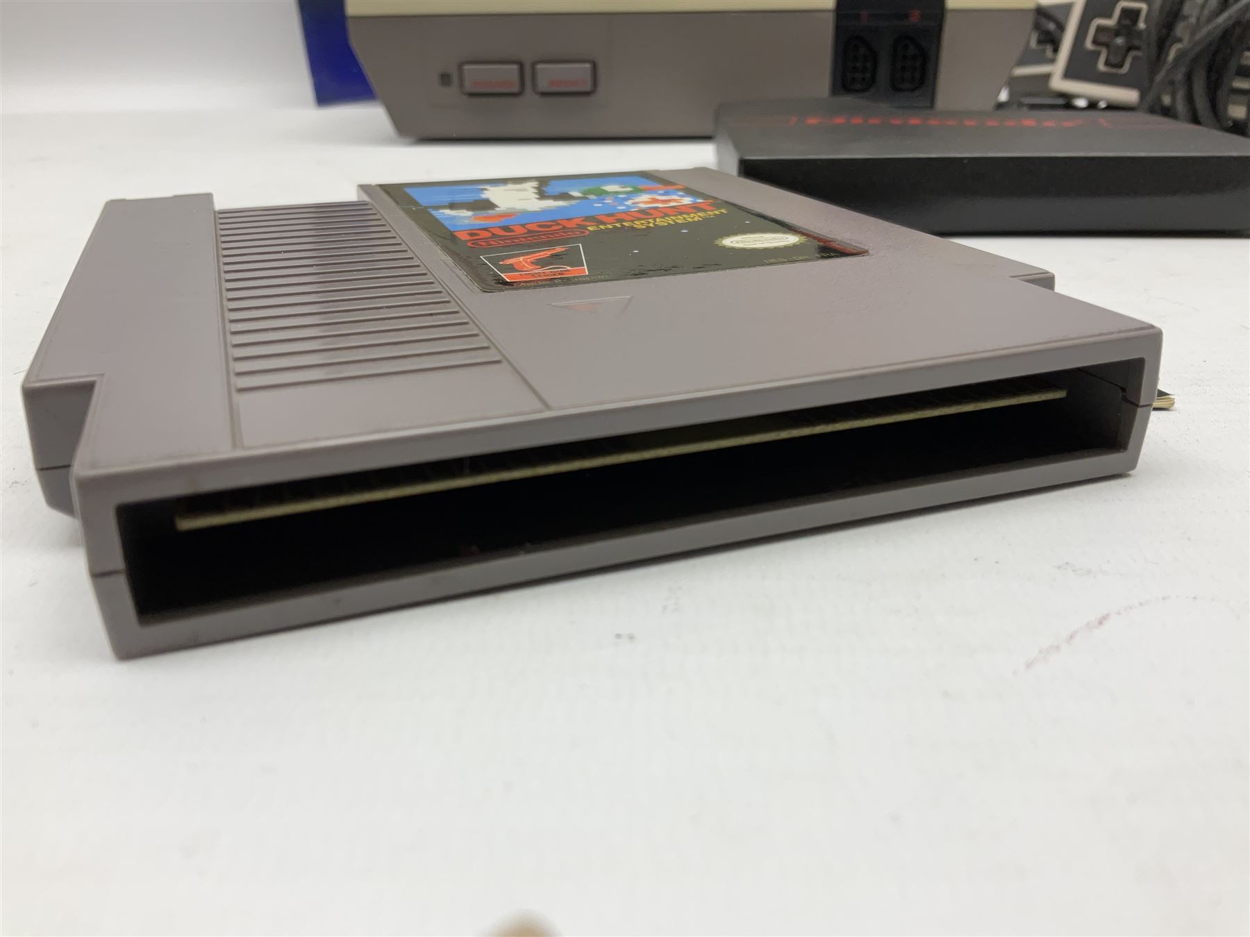 Nintendo Entertainment System (1985) console with two controllers, accessories and instruction booklet. NES Games ‘Duck Hunt’ with Nintendo Zapper gun, ‘Pinball’ and ‘Super Mario Bros.’, all with original sleeves and instruction booklets. NES game ‘Super Mario Bros. 2’ cartridge only