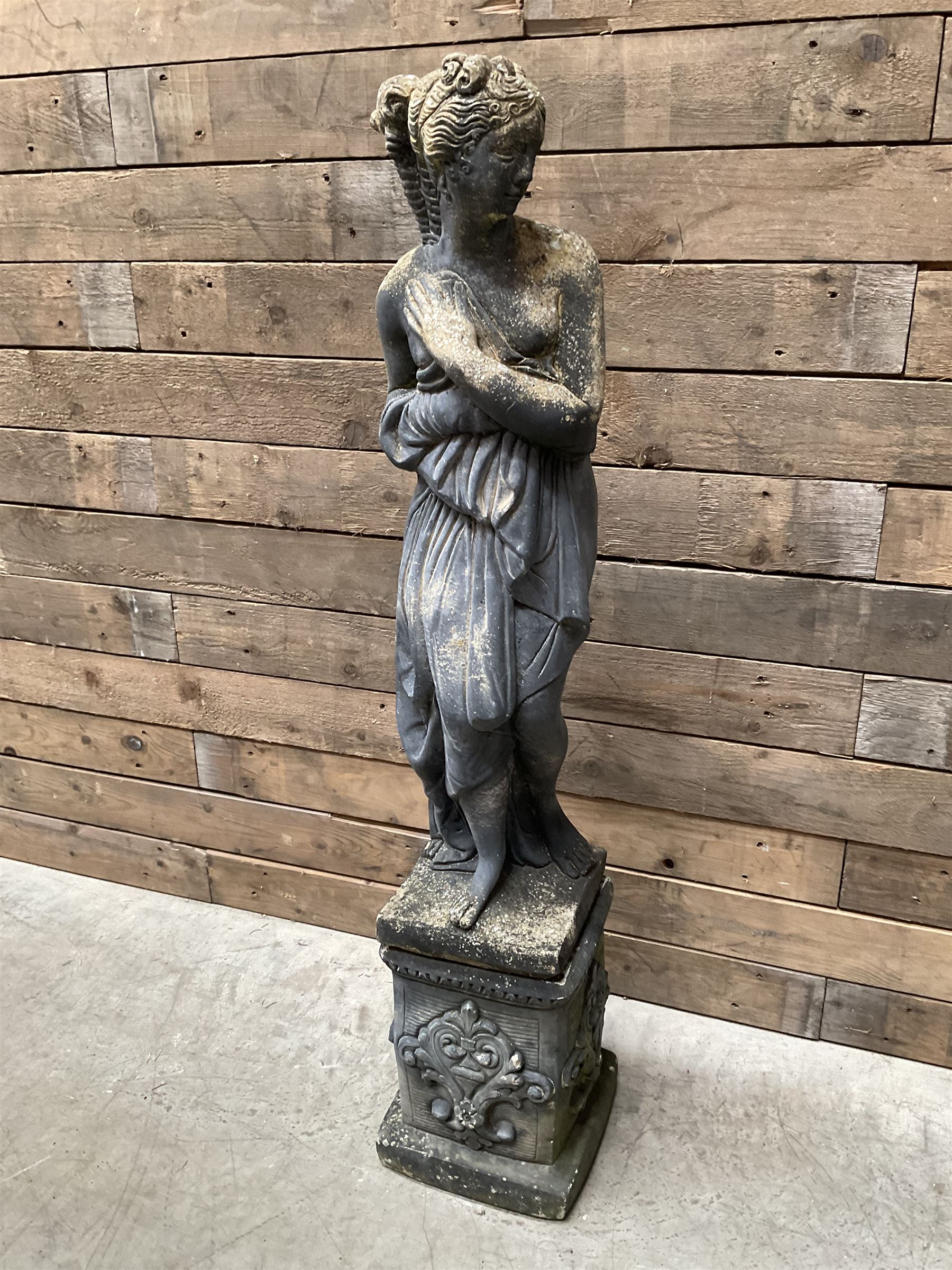 Cast stone weathered garden statue of Venus on pedestal