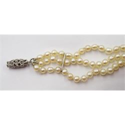 Three strand pearl necklace, with platinum diamond milgrain clasp and a single strand graduating pearl necklace with 18ct white gold clasp set with a diamond