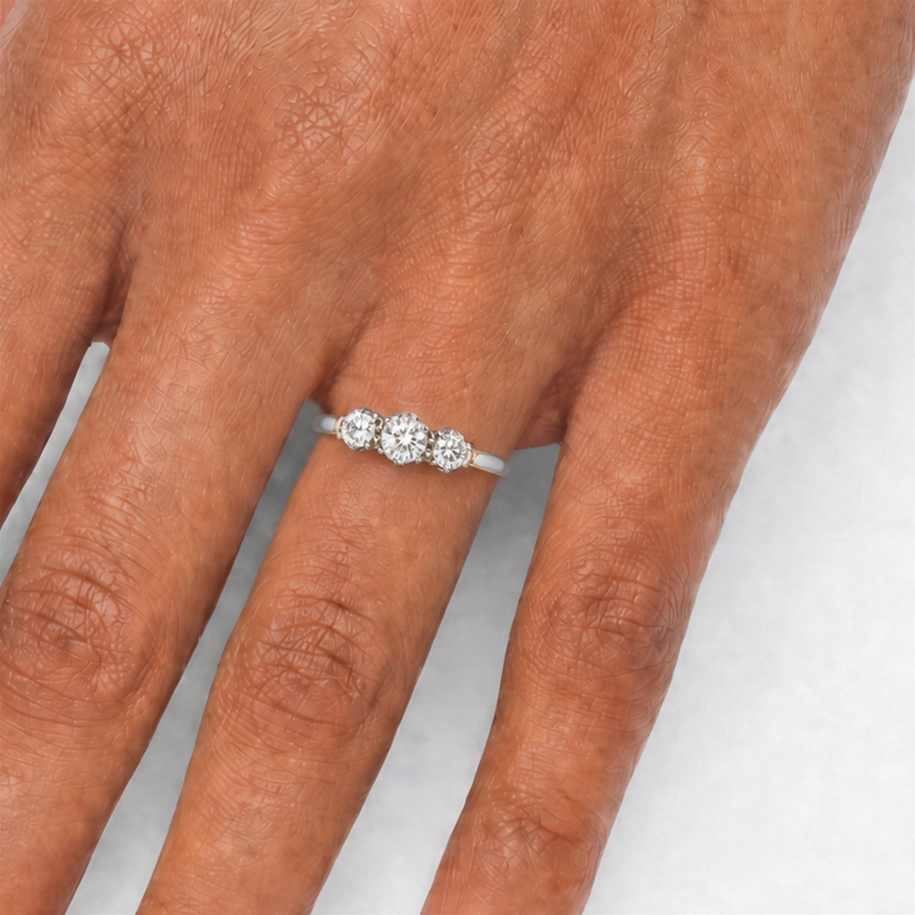 Gold three stone diamond ring, each multi claw set with an old cut diamond, stamped 18ct Plat, total diamond weight approx 0.65 carat