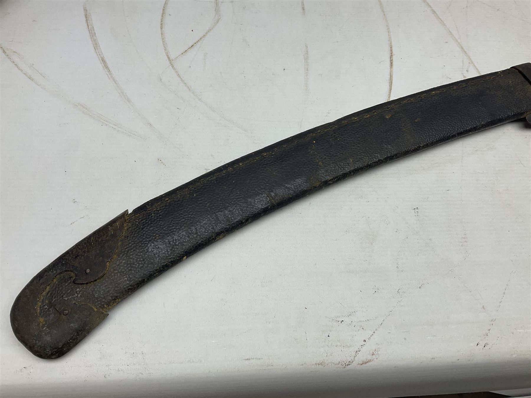 Chinese Boxer Rebellion Period Sword, 69.5cm heavy curved single edge blade with single narrow fuller, plain iron dished circular guard, iron pommel and ferrule with plaited cord bound grip; in skin covered wooden scabbard with iron chape and long suspension mount L95cm overall