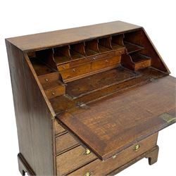 George III oak bureau, the fall front with rest enclosing pigeonholes, drawers and slide revealing storage well, fitted with two short and two long drawers, shaped brass handle plates and ring handles 