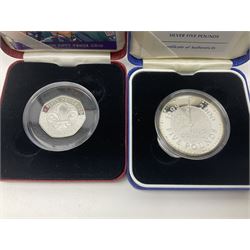 Queen Elizabeth II 2000 'The Queen Mother' silver proof five pound coin, 2000 'Millennium' silver proof five pounds, 2007 'Scouts' silver proof fifty pence, Tristan Da Cunha 2014 9ct gold 1 gram gold one crown coin, all cased with certificates and a 'Prince Charles 60th Birthday Commemorative Coin Cover' containing a 2008 silver proof five pound coin in folder (5)