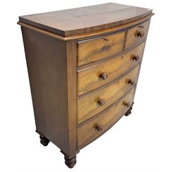 Victorian mahogany bow-front chest, fitted with two short over three long drawers with step canted facias and turned handles, on chunky turned feet
