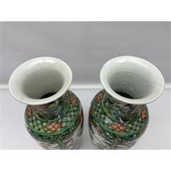 Pair of Chinese famille verte vases of baluster form decorated with phoenixes and birds in a floral garden, H31cm