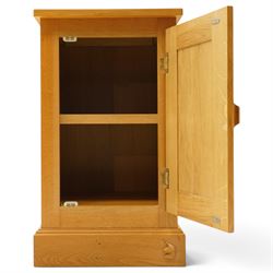 Unicornman - craftsman made oak bedside cupboard, raised back over panelled cupboard, on skirted base applied with carved unicorn signature, by Geoff Gell of Coxwold