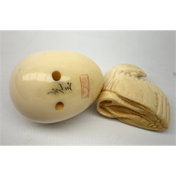 A Japanese ivory netsky modelled as a chick hatching from an egg, with marks beneath, together with a further netsky modelled as a seated chicken, also marked, a carved ivory cheroot holder, and two small carved ivory elephants, plus a Japanese stand modelled in the form of a crane, with character marks to base, a Japanese bamboo detailed teapot, cloisonne circular  pot, and an embroidered pouch and purse. 