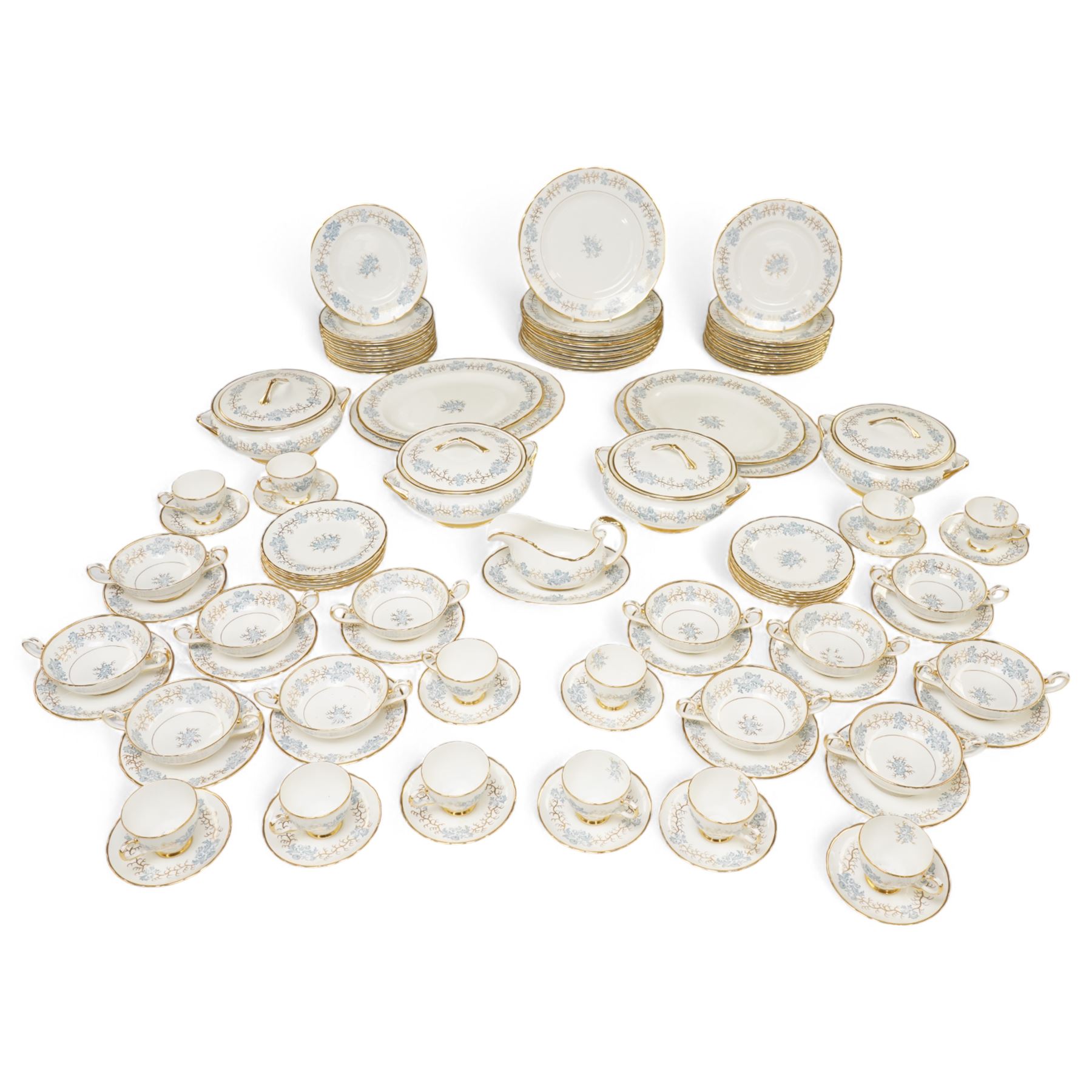 Tuscan Avondale dinner and coffee service for twelve covers with a blue and gilt border pattern comprising  twelve dinner plates, twelve dessert plates, twelve side plates, twelve two handled soup bowls and stands, four vegetable dishes and covers,  four graduated meat plates, sauce boat and stand, twelve coffee cups and saucers and twelve tea plates (106)