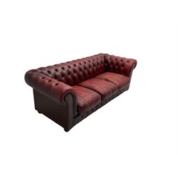Mid-20th century chesterfield three seat sofa, upholstered in oxblood buttoned leather, the scrolled arms with studwork