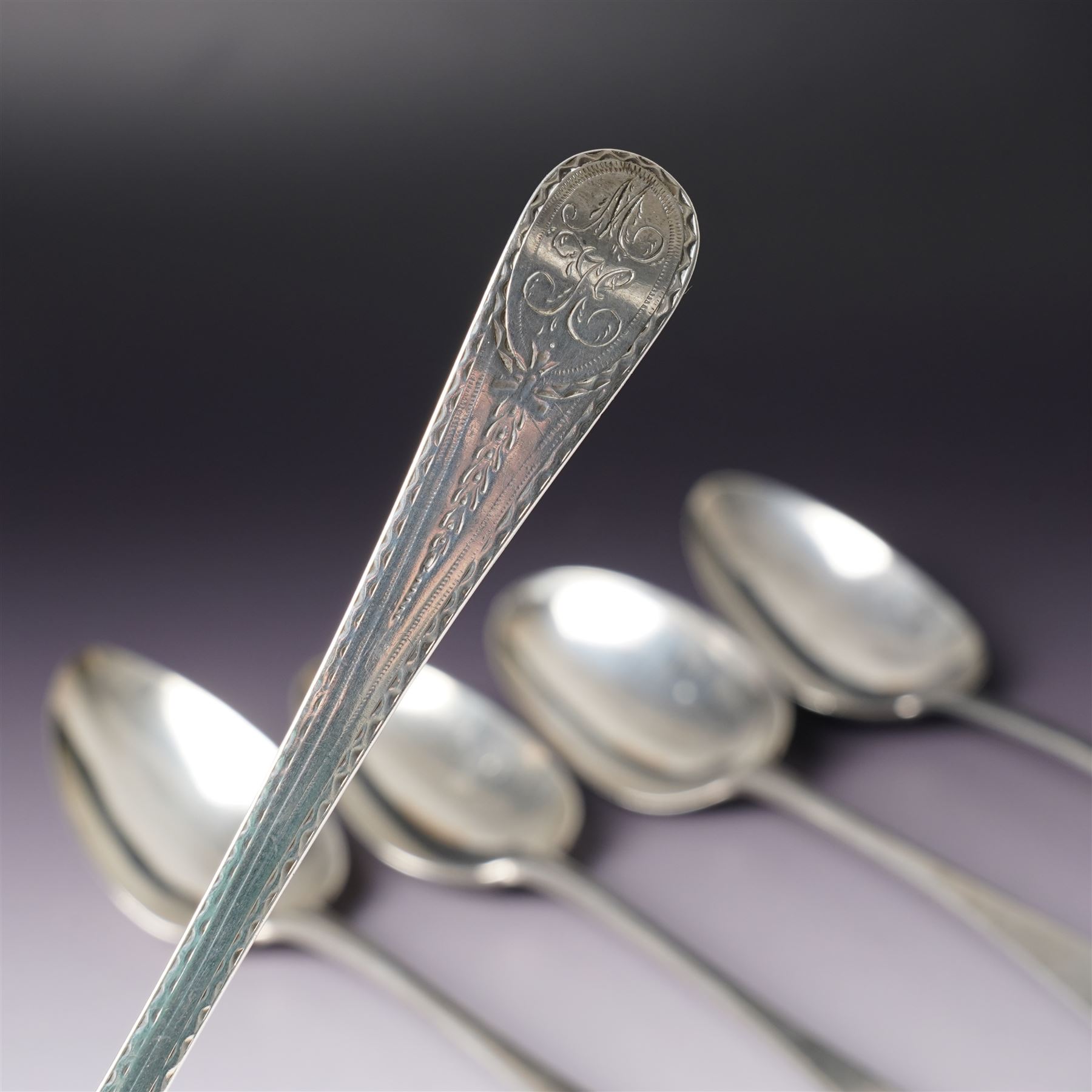 George III silver bright cut table spoon London 1781 Maker Hester Bateman, another London 1782 Maker Thomas Wallis I and three others (5)