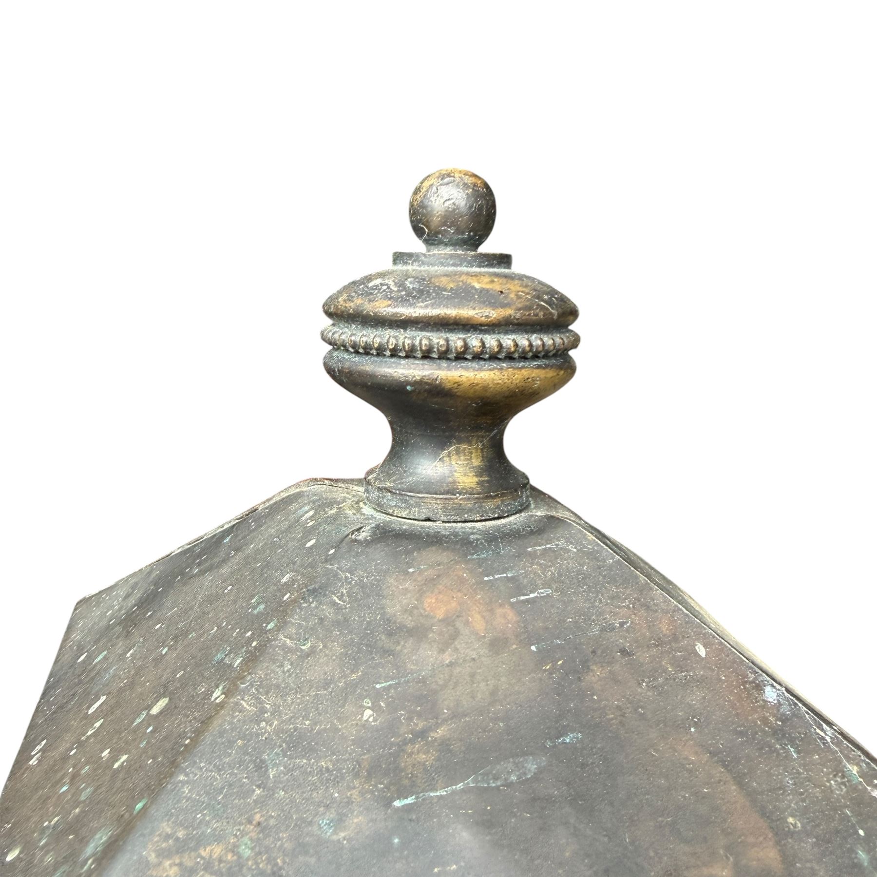 Early 20th century brass and cast iron garden lantern or street light, turned finial over four panel glazed body, cast iron base