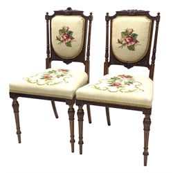Pair of Victorian walnut salon chairs by James Winter and Sons 151-155 Wardour Street, London, stamped under, the frame with delicate floral carving, seat and back upholstered in floral needlework fabric, raised on ring turned and fluted supports 