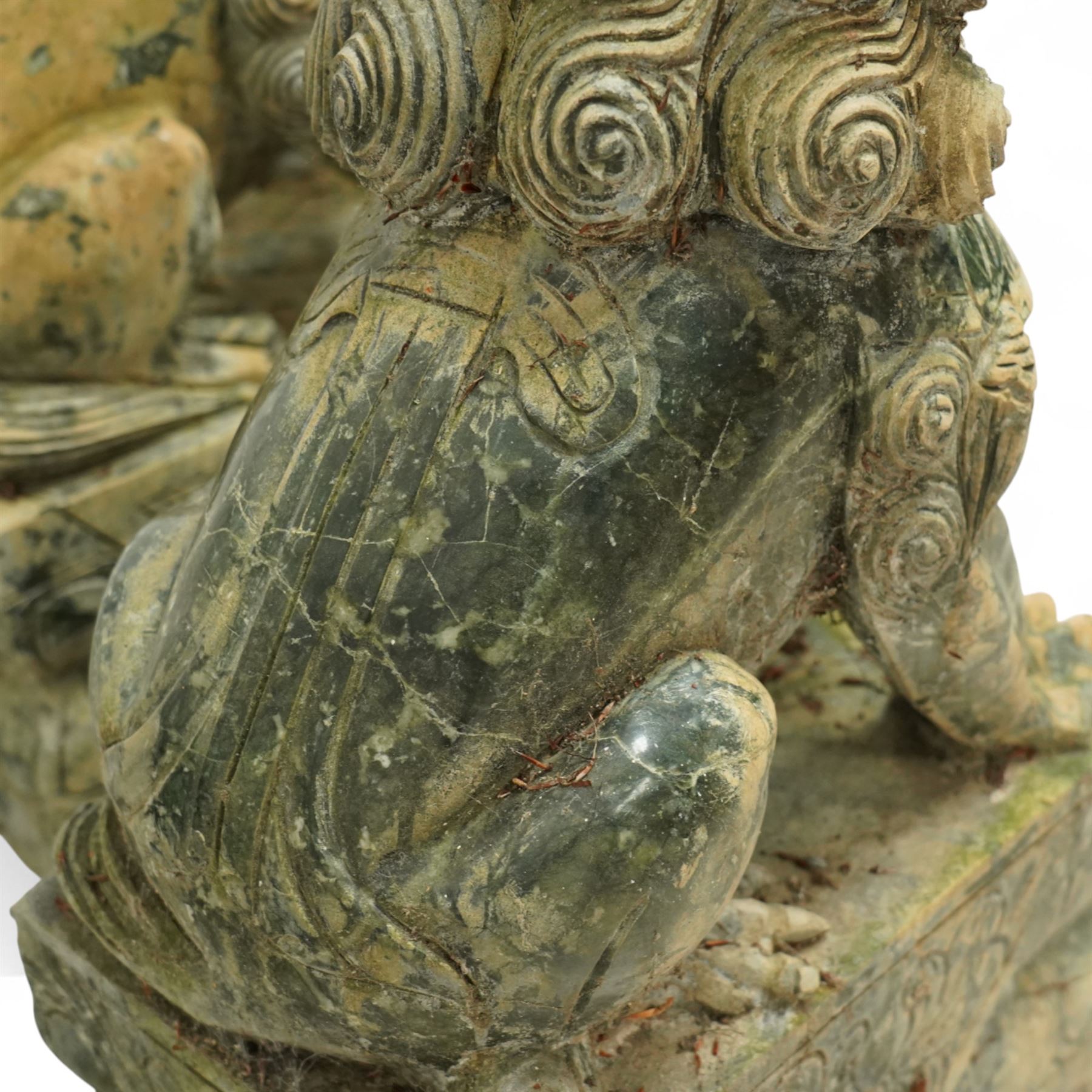 Pair of Chinese hardstone carved Foo dogs, each finely carved seated on rectangular plinth bases with detailed manes, collars and bells, the male with paw resting on a ball, the female with cub, in mottled green stone resembling jade