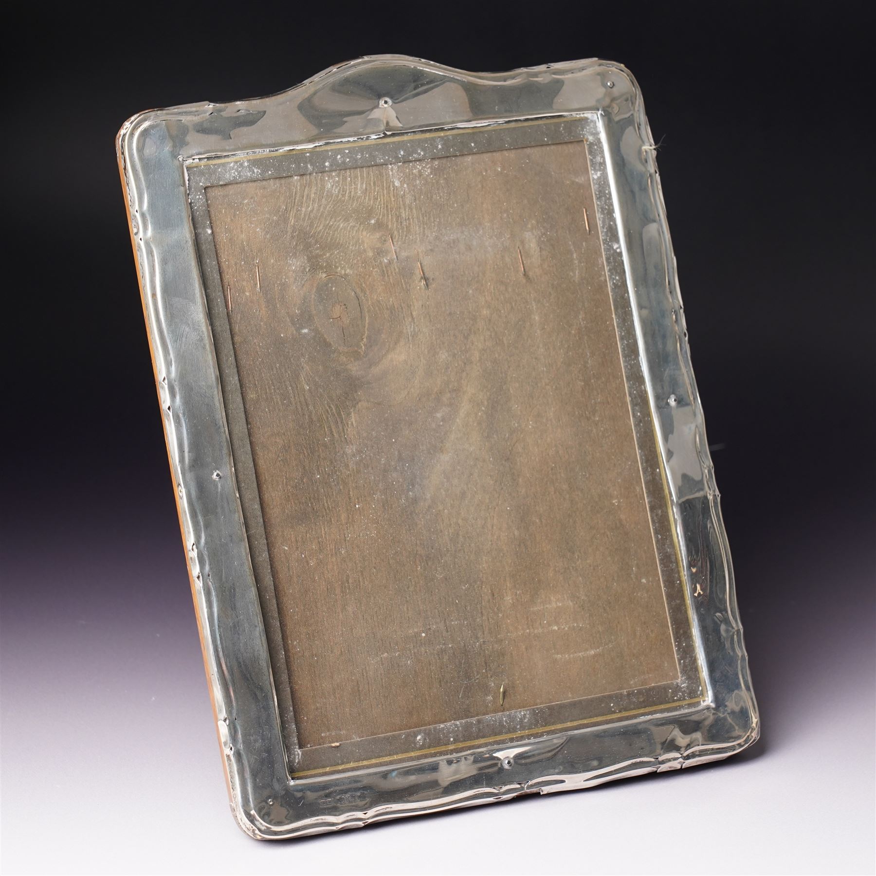 Silver upright photograph frame of plain design, aperture size 21cm x 15cm marks rubbed