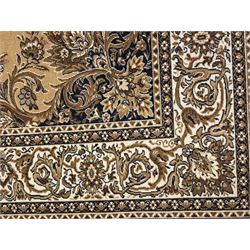 Persian design golden beige ground rug, the field with symmetrical scrolling foliate and floral designs, central floral medallion, bordered by a multi-layered band with floral and vine patterns in contrasting beige and dark brown tones