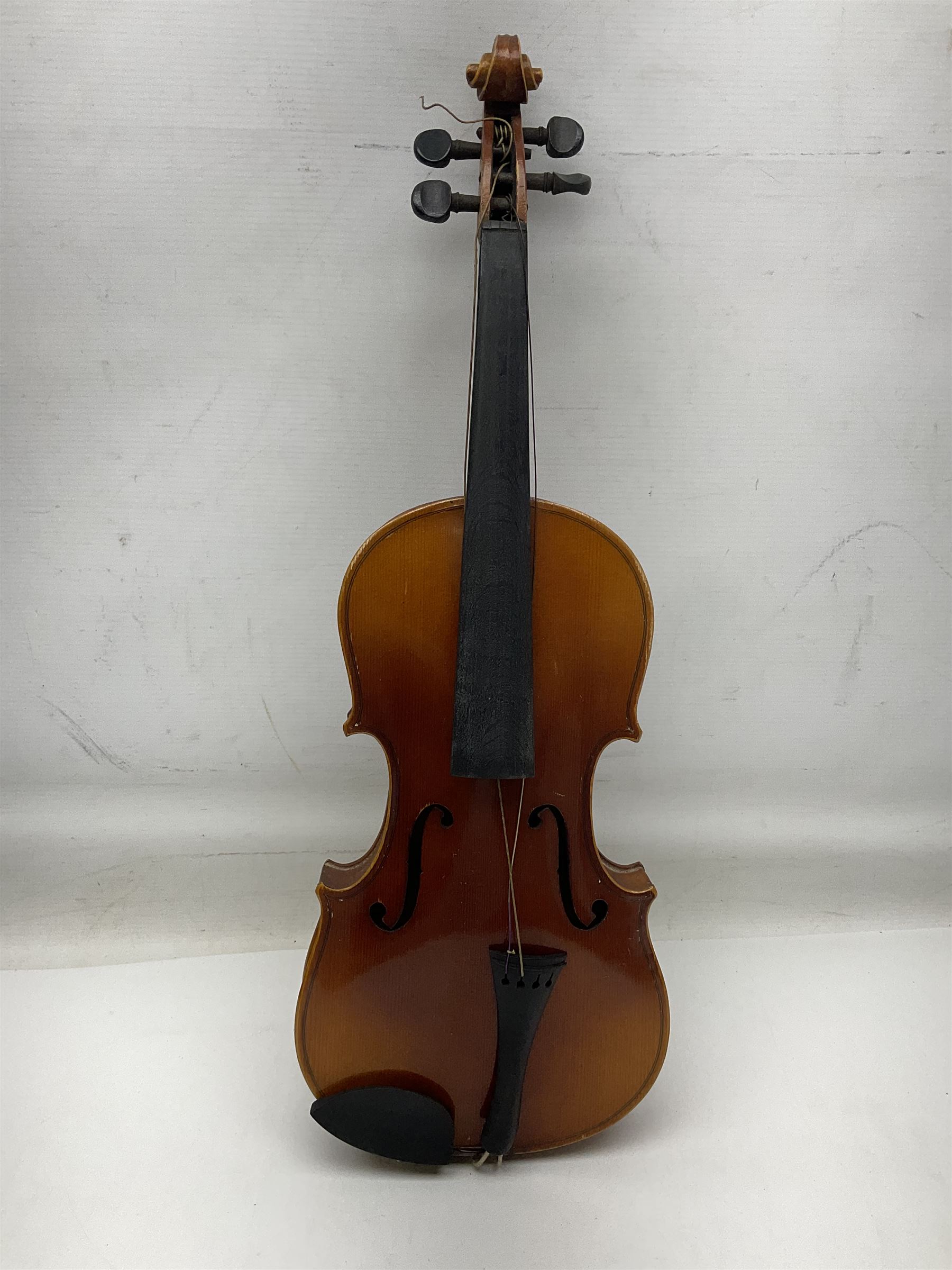 Czechoslovakian violin c1920 with 36cm two-piece maple back and ribs and spruce top, bears label 'Copy of Antonius Stradivarius Made in Czechoslovakia' L59cm; in carrying case; 1950s Czechoslovakian violin; and 195os Czechoslovakian three-quarter size violin; both cased (3)