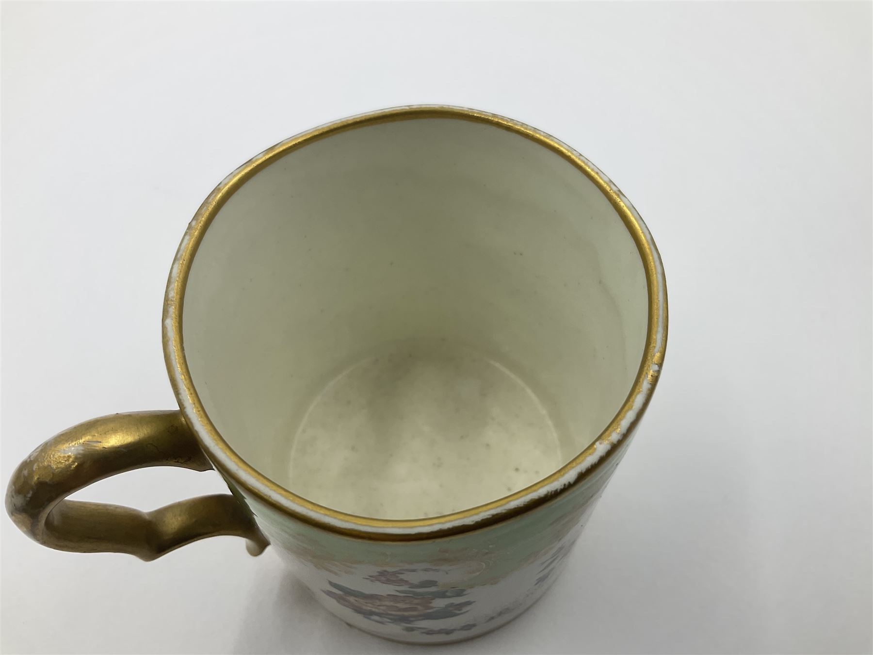 Sèvres soft paste porcelain coffee can and saucer with date code for 1754, painted and gilded with flowers, dangling from the shaped green border, interlaced LL monogram enclosing the date letter A above painters mark for Dodin, coffee can H7cm, saucer D14.5cm