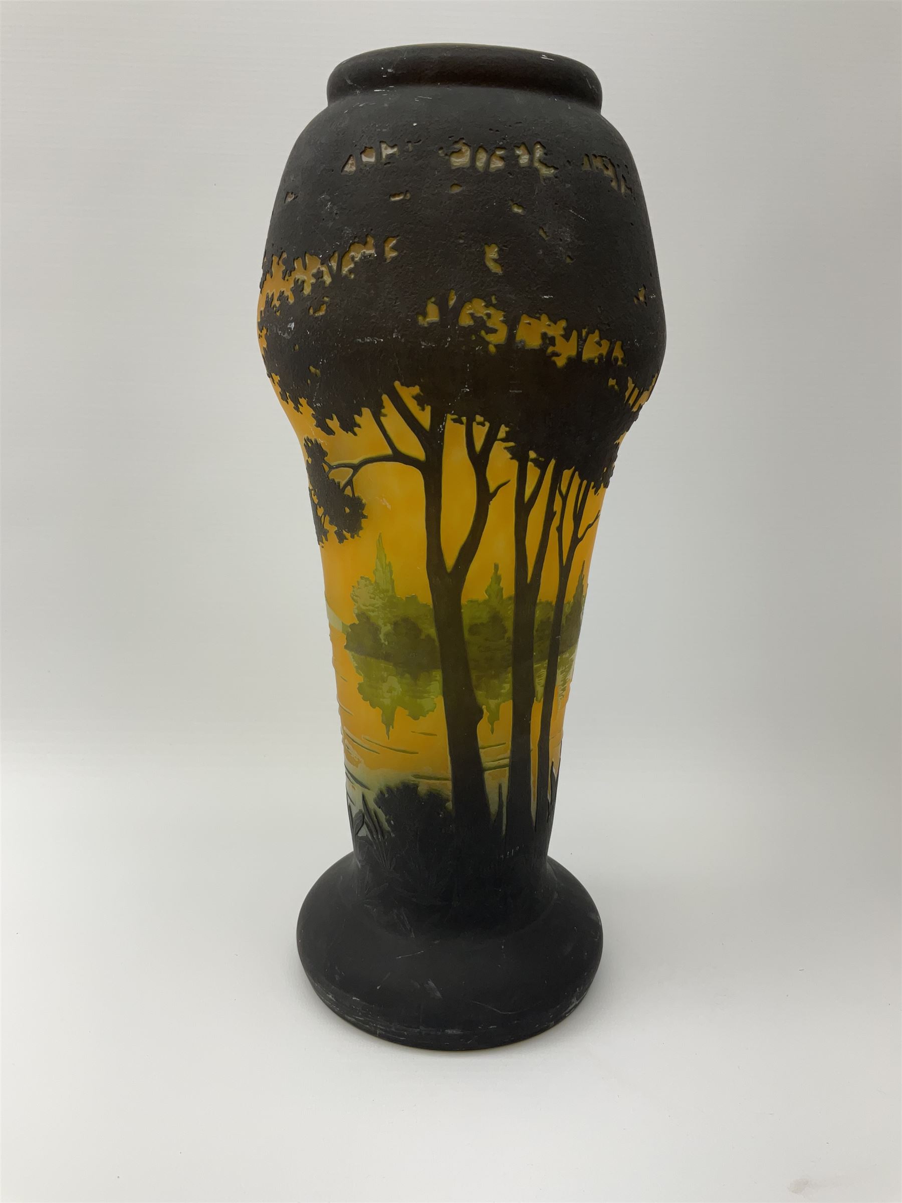 Reproduction Daum Nancy art nouveau style overlay and cut glass vase  decorated with woodland and a lake scene on a yellow ground, H35cm. 