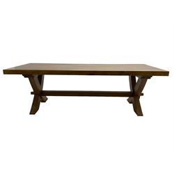 Solid oak rectangular extending dining table, raised on an X-frame base united by single stretcher, with two additional leaves