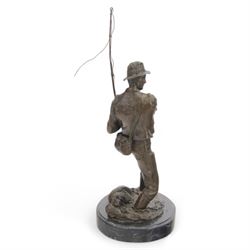 Bronzed figure of a fly fisherman, signed Milo, upon an oval marble base, H42.5cm