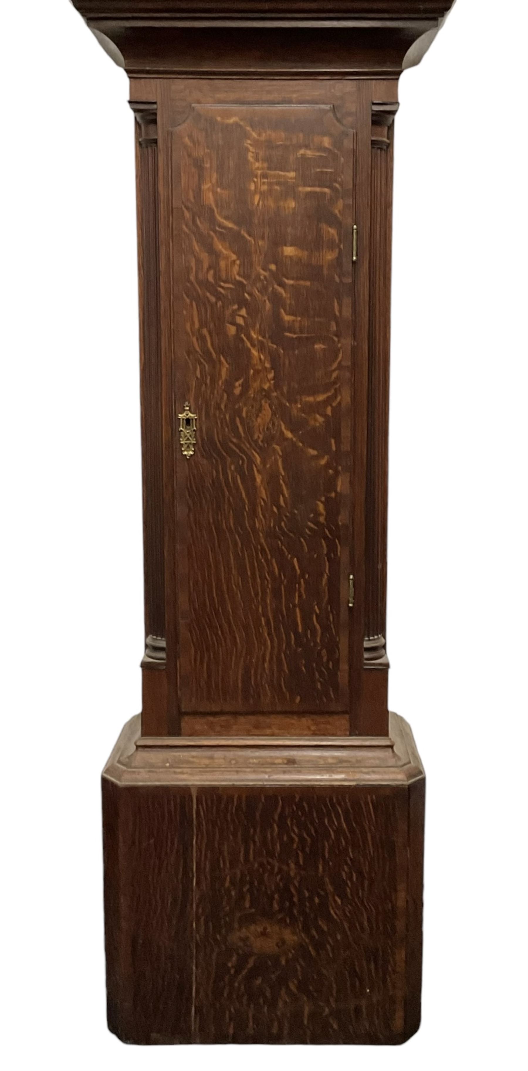 Late 18th century oak 8-day longcase clock, with a swan necked pediment and brass paterie, 
break arch hood door flanked by detached reeded pilasters, trunk with recessed quarter pillars and a long flat topped door, on a square plinth with canted corners, early painted dial with Arabic numerals and floral decoration to the arch and spandrels, with stamped brass hands and date recorder, weight driven two train movement with baluster movement pillars and an internal countwheel strike (bell missing). With pendulum and weights.  No makers name.
