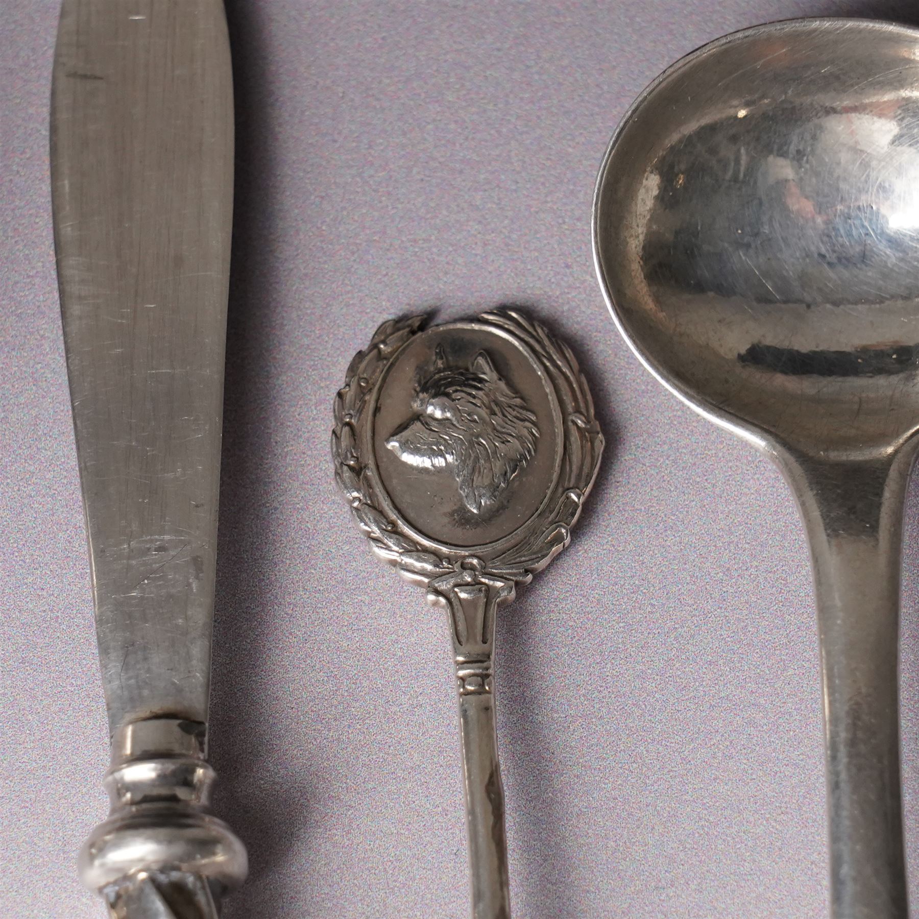 Assorted silver including two 19th century condiment spoons, coffee spoon, napkin ring, knife, two silver brooches and a charm 
