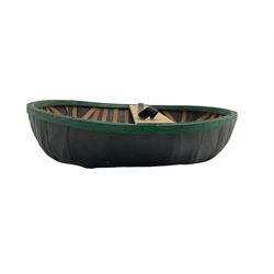 Coracle boat, comprised of woven planks and waterproof covering with single plank seat and strap