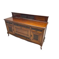 Edwardian carved walnut sideboard, raised back carved with shell and scrolling foliage, fitted with three drawers, two cupboards and fall front compartment, on cabriole feet