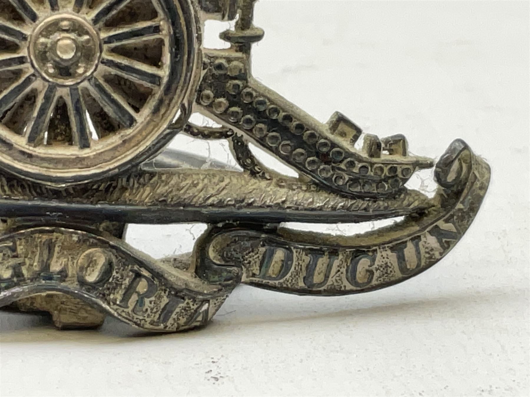 Trench Art - three WW2 brass shell case ashtrays, one mounted with Royal Artillery cap badge and button and one mounted with RA button; together with a pair of place name holders each formed from a Royal Artillery cap badge (5)