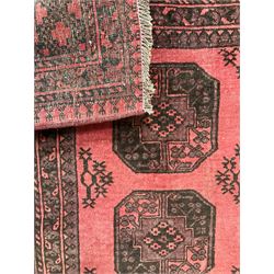 Turkman Bokhara red ground rug, four Gul motifs enclosed by multiple geometric patterned border bands