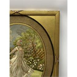 George III silkwork picture, of oval form depicting a female figure in garden setting, within a silkwork border detailed with verse from Robert Burns Bonnie Peg, 'Her air sae sweet, and shape complete, The Queen of Love did never move, Wi' Motion mair enchanting!', and monograms 'FV' and 'SM', in reeded gilt frame and gilt mount, indistinctly inscribed in pencil verso, overall H36cm L30.5cm