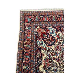 Persian Bidjar ivory ground carpet, decorated all-over with stylised floral motifs and interlacing branch, five band border decorated with flower heads 