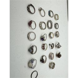 Twenty-two silver and stone set silver rings including turquoise, garnet, cubic zirconia, moonstone, topaz, tanzanite and amethyst, stamped 925