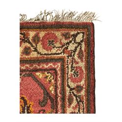 Belgian Sultan woollen ground rug, central navy field densely decorated with floral sprays and geometric patterns (192cm x 135cm); handwoven tribal terracotta ground rug (121cm x 71cm); Persian crimson ground runner, all over stylised floral and foliate motifs (266cm x 94cm)